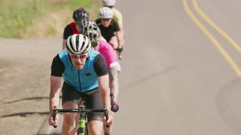 Group of cyclists on road.  Fully released for commercial use. Stock Footage 84551012