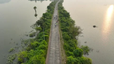 Group of cyclists team ride bicycles on road in nature surrounded by mounta.. Stock Footage 283895992