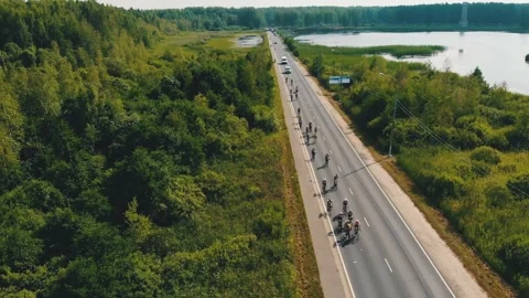 Group of cyclists team ride on bridge over river. Aerial shot of bicycle race 스톡 동영상 244322460