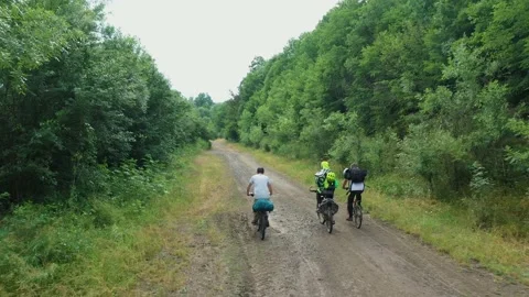 Group of cyclists team ride down gravel mountain road Stock Footage 236491592