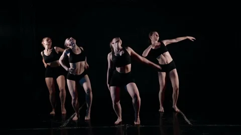 A group of dancers has the concept of dancing in slow motion on a black Stock Footage 159584429