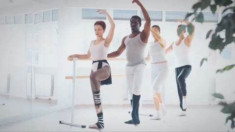 Group of dancers practicing develope at barre Stock Footage 279958816