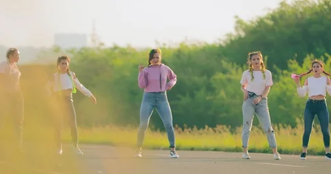 Group of dancers synchronously dancing hip-hop on the street. Girls dancing Stock-Footage 111228338