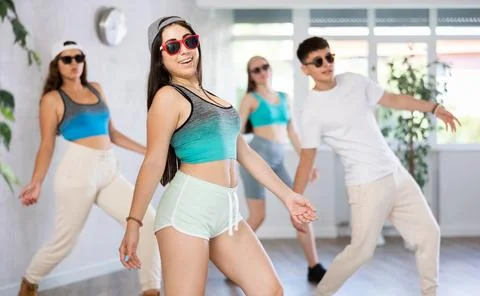 Group of dancers training modern dance moves in studio Stock Photos