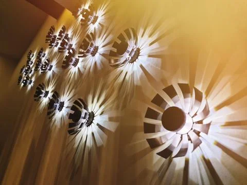 A group of decorative modern light elements in the interior on the wall, giving Stock Photos