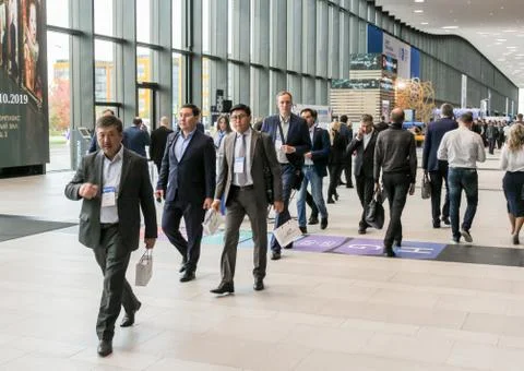 A group of delegates walking through the lobby. Stock Photos