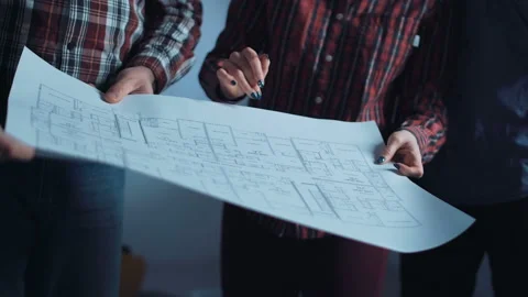The group of designers discussing blueprints Stock Footage 100556493