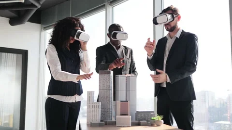 Group of developers using virtual reality simulators, standing around table with Stock Footage 233605431