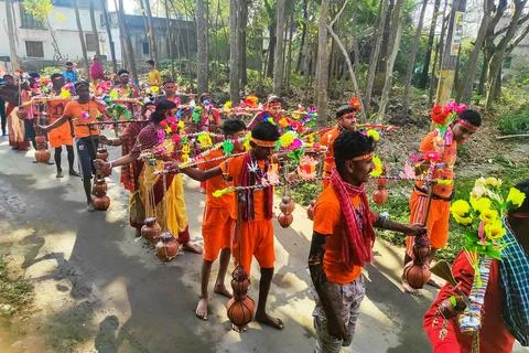 A group of devotees carrying holy Ganges water and going through the villag Stock Photos
