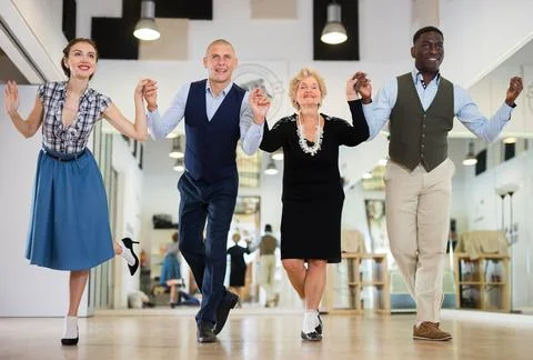 Group of different age dancers preparing swing performance Stock Photos