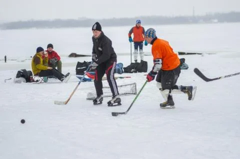 Group of different aged people playing hockey Stock Photos