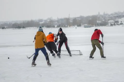 Group of different aged people playing hockey Stock Photos