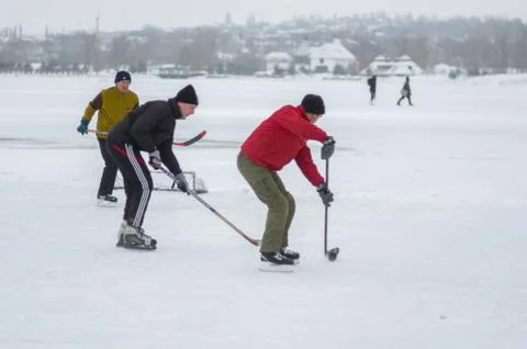 Group of different aged people playing hockey Stock Photos