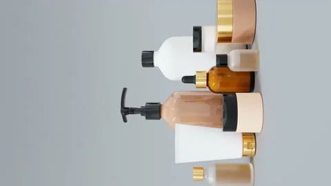 Group of different beige and brown glass and plastic cosmetic bottles and jars Stockbeeldmateriaal 237123065