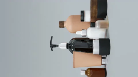 Group of different beige and brown glass and plastic cosmetic bottles and jars Stock Footage 237123593