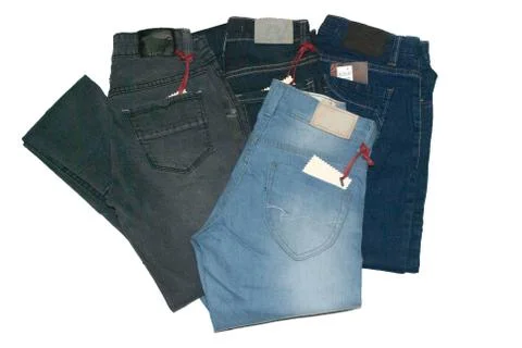 Group of different blue jeans stack isolated on white background. Stock Photos