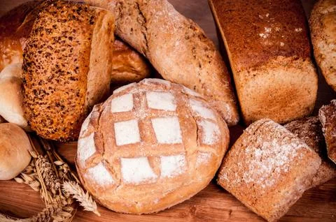 Group of different bread's type on wooden table Stock Photos