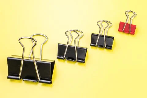 Group of different clips with one highlighted red clip. Stock Photos