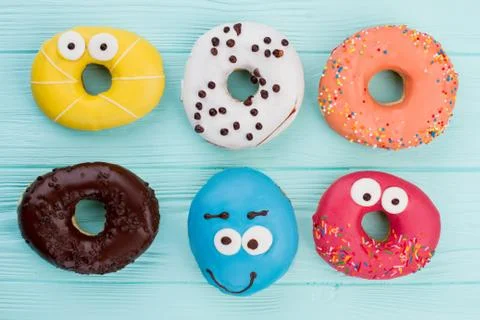 Group of different donuts on color background. Stock Photos