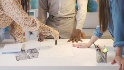 Group of different ethnicities working on architectural project. Stock Footage 228804751