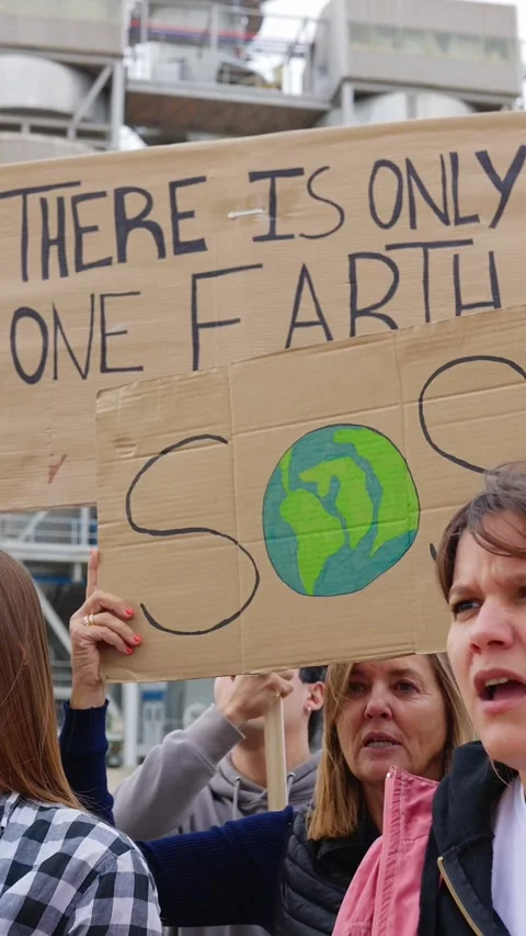 Group of different people holding posters protesting against climate change Stock Footage 312235952