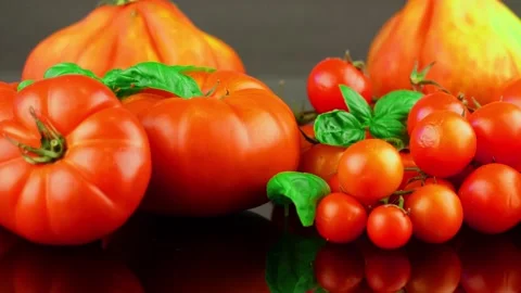Group of different tomatoes with basil leaf on black backgroubd 動画素材 136973609