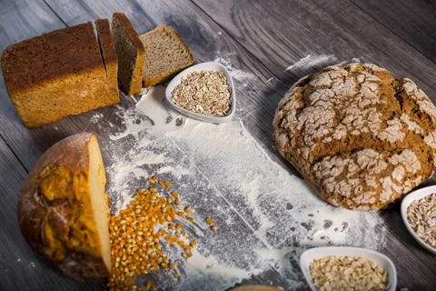 Group of different types of bread on old wooden table Stock Photos