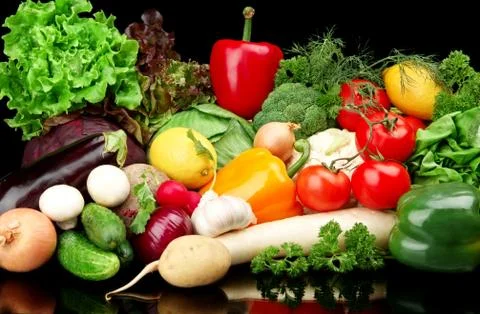 Group of different vegetables on black board Stock Photos
