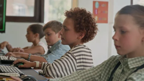 Group of Diligent Schoolchildren Looking at Computer Screens and Typing Stock Footage 316479702