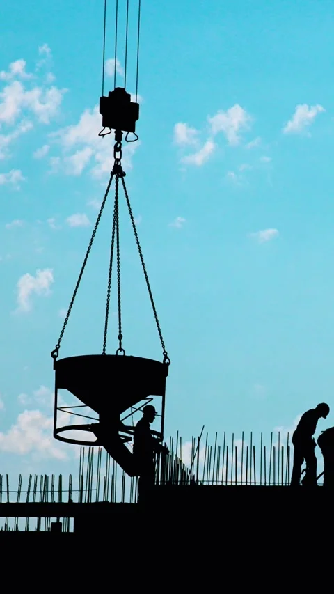 A group of diligent workers is actively engaged on a construction site under a Stock Footage 290191828