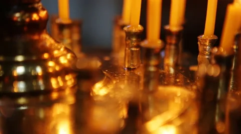 Group of dimly lit, burning white candles create mood, ambiance, close up, black Stock Footage 66004007