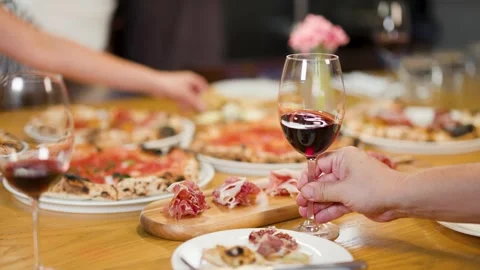 Group Dining with Neapolitan Pizza and Red Wine at Italian Restaurant Stock Footage 340005997