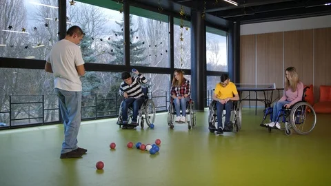 Group of disabled people playing bocce game Stock Footage 125726764