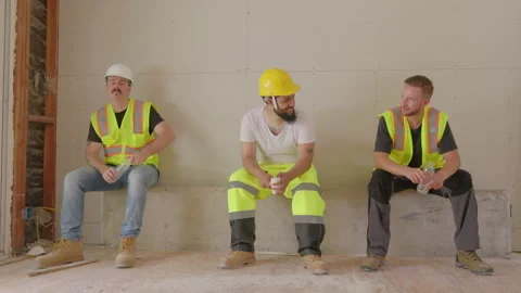 A group of diverse builders is collaborating effectively at a bustling Stock Footage 306050522