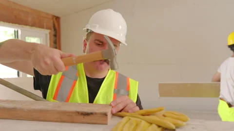 A group of diverse builders is currently collaborating on the process of house Stock Footage 305461890