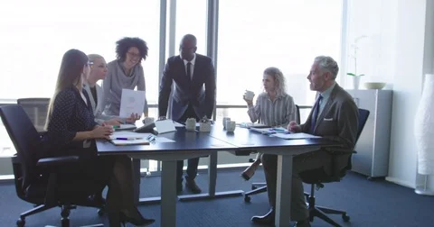 Group of diverse business people in formal clothing inside their office dis.. Stock Footage