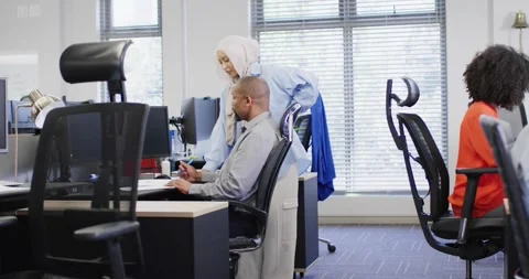 Group of diverse business people using computer and talking in office, slow Stock Footage 340964005