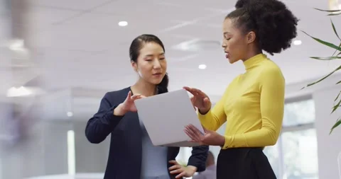 Group of diverse business people using laptop and talking in office, slow motion Stock Footage 341851342