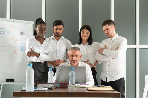 Group of diverse colleagues working on the computers in the modern office or Stock Photos