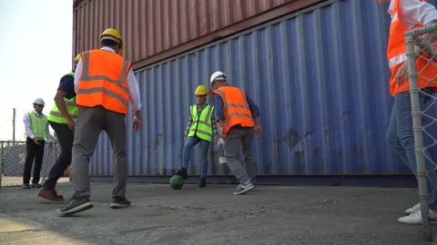 Group of diverse container worker take a break playing football together at w Stock Footage 157715720
