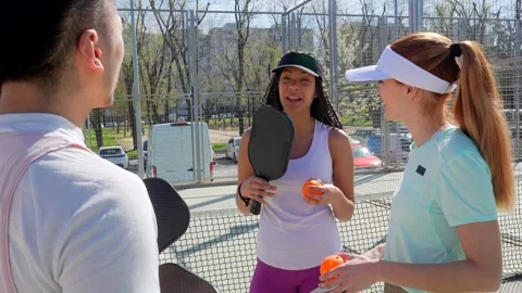 Group of diverse friends socializing after pickleball game Stock Footage 334009769