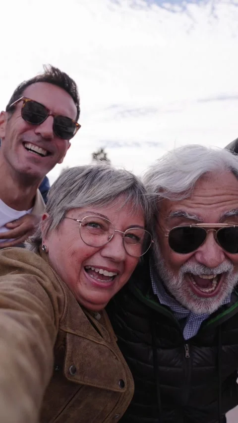 Group diverse funny middle-aged tourist friends posing laughing taking selfie Stock Footage 264984594