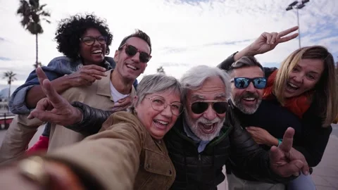 Group diverse funny middle-aged tourist friends posing laughing taking selfie Stock Footage 265712156