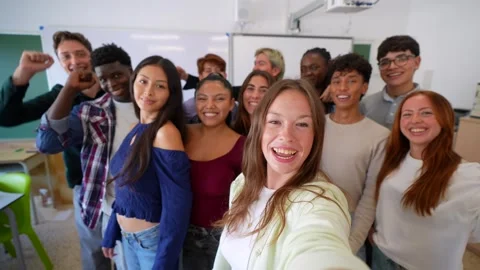 Group of diverse high school students taking a selfie video in the classroom Stock Footage 345051850