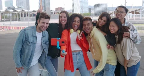Group of diverse millennials recording video or taking a photo for social media Stock Footage 230284292