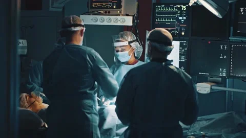 Group of diverse multi-ethnic medical staff performing surgical operation in Stock Footage