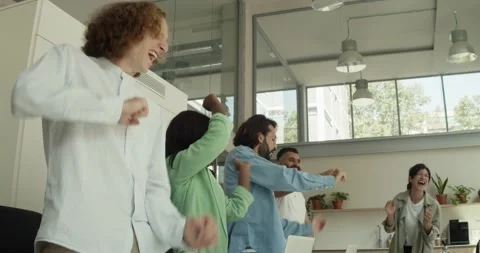 Group of diverse office workers dancing happily in the office Stock Footage 164863386