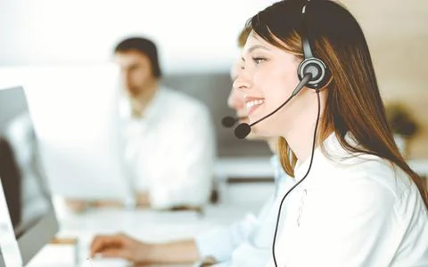 Group of diverse operators at work in call center. Beautiful asian woman sitting Stock Photos
