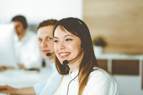 Group of diverse operators at work in call center. Beautiful asian woman sitting Stock Photos