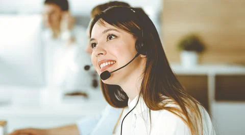 Group of diverse operators at work in call center. Beautiful asian woman sitting Stock Photos